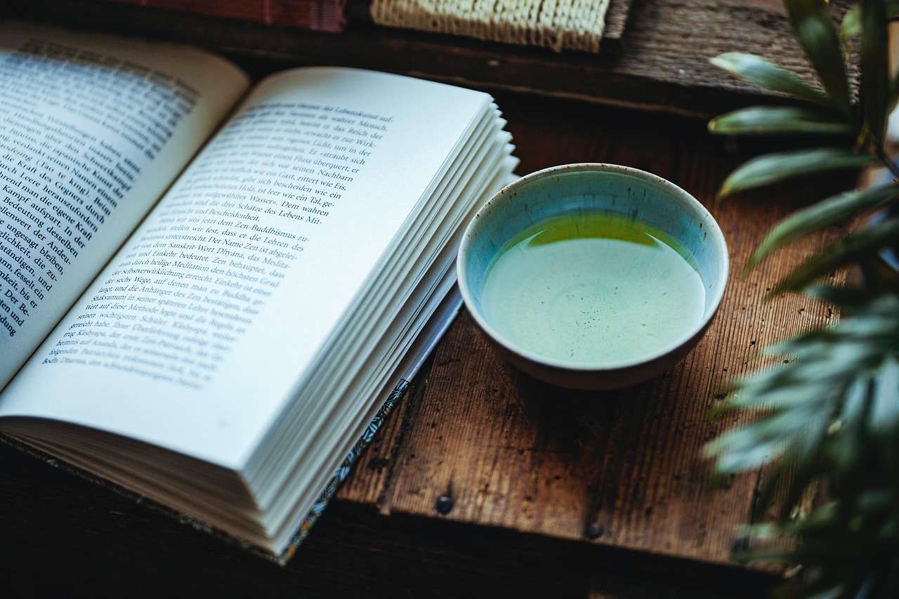 open book with drink next to it